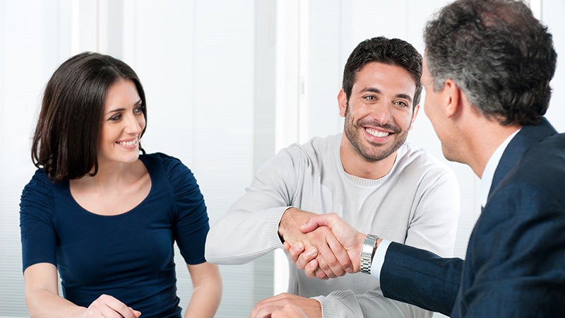couple shaking hands with salesman Grand Island Chevrolet GMC in GRAND ISLAND NE